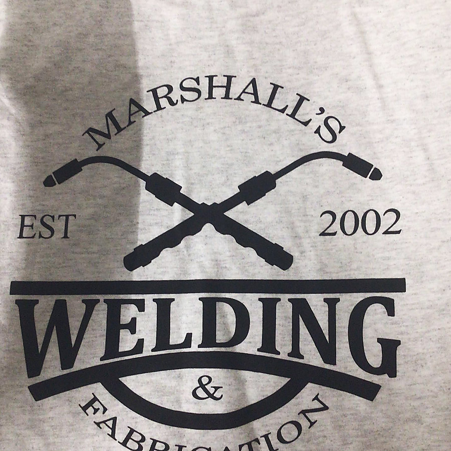The shop mark: crossed torches, Marshall’s Welding & Fabrication, est. 2002