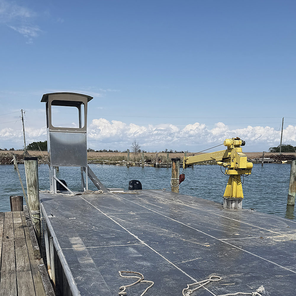 OSCAR tied up at the dock, the helm stand and the yellow crane on her deck