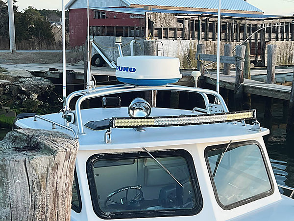 A rail across a cabin top, radar and light bar on it