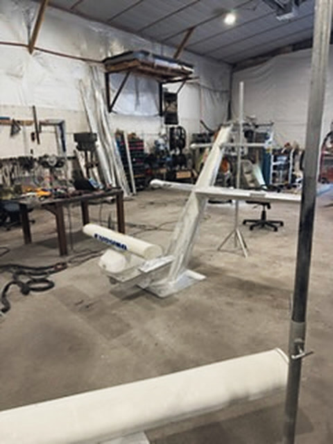 A mast in the shop, gear mounted on the crossbar