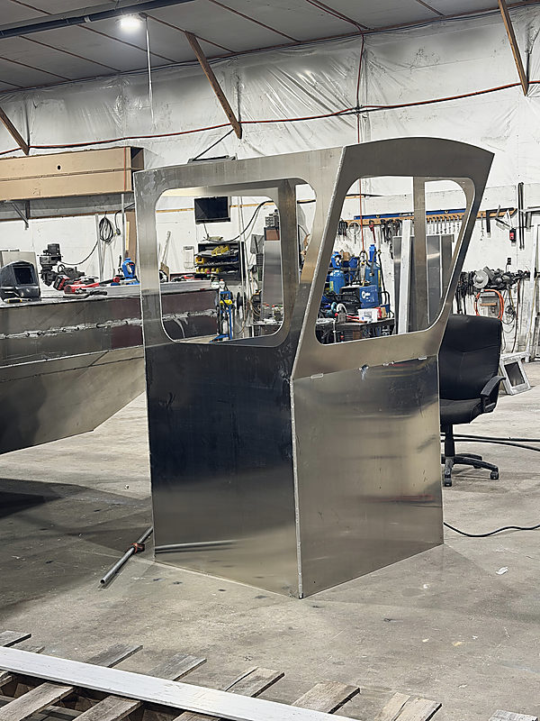 An aluminum pilot house in the shop, the windows cut out