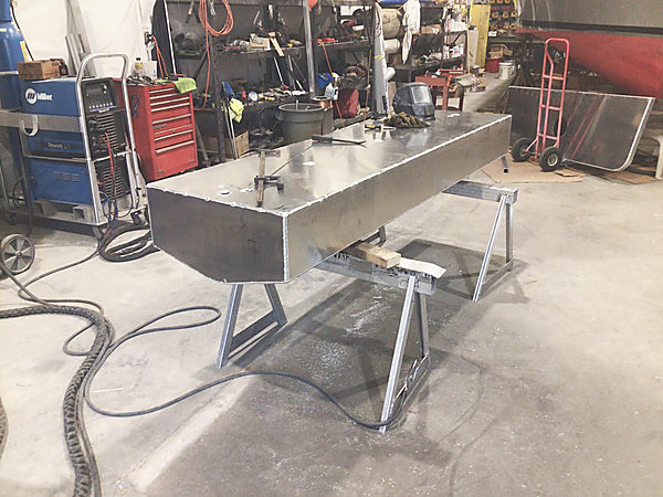 An aluminum tank on the stand, lid off